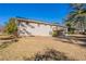This property features a sprawling backyard with mature trees and a wooden deck at 2424 West Rd, Riverdale, GA 30296