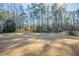 Expansive backyard featuring a sprawling lawn and perimeter of mature trees, offering privacy at 2424 West Rd, Riverdale, GA 30296