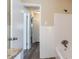 Neutral tone bathroom featuring wood grain floor and tiled tub with shower head at 2424 West Rd, Riverdale, GA 30296
