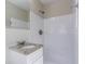 Bathroom featuring white tiled shower and walls with granite vanity top at 2424 West Rd, Riverdale, GA 30296
