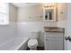 This well-lit bathroom features subway tile and a granite vanity at 2424 West Rd, Riverdale, GA 30296