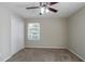 Bedroom featuring neutral walls, carpet, closet, and a ceiling fan with windows at 2424 West Rd, Riverdale, GA 30296