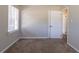 Bedroom featuring neutral walls, carpet, and a doorway to another room at 2424 West Rd, Riverdale, GA 30296