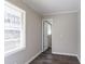 A room with gray wood flooring, natural light from the window, and neutral walls at 2424 West Rd, Riverdale, GA 30296