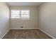 Bedroom featuring neutral walls, carpet, and a window with blinds at 2424 West Rd, Riverdale, GA 30296