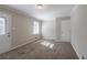 Carpeted bedroom with natural light, neutral walls, and convenient access to the exterior at 2424 West Rd, Riverdale, GA 30296