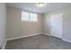 This bedroom features luxury vinyl plank flooring, a window with blinds and neutral paint at 2424 West Rd, Riverdale, GA 30296