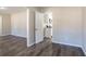 Spacious entryway with gray wood flooring leading into a bright, white kitchen at 2424 West Rd, Riverdale, GA 30296