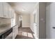Kitchen with white cabinets, granite countertops, stainless appliances, and hardwood floors at 2424 West Rd, Riverdale, GA 30296