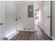 Functional laundry room with gray wood flooring and access to the kitchen at 2424 West Rd, Riverdale, GA 30296