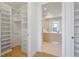 Walk-in closet with custom shelving and drawers, adjacent to a well-lit bathroom, offering ample storage space at 2425 Peachtree Rd # 508, Atlanta, GA 30305