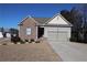 Brick ranch home with 2-car garage and landscaped lawn at 7229 Deering Ct, Douglasville, GA 30134