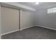 Basement bedroom with grey carpet and window at 3887 Mcgill Ln, Decatur, GA 30034