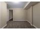 Basement bedroom with grey carpet and door to hallway at 3887 Mcgill Ln, Decatur, GA 30034