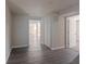 Basement hallway with grey vinyl flooring and doors to bedrooms at 3887 Mcgill Ln, Decatur, GA 30034