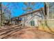 Back of house, deck, fenced yard, and trees at 3887 Mcgill Ln, Decatur, GA 30034