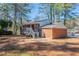 View of the backyard featuring a brick home with a deck and stairs leading to the yard at 5938 Baywood Ln, Riverdale, GA 30296
