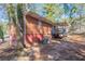 View of the backyard featuring a brick home with a deck and stairs leading to the yard at 5938 Baywood Ln, Riverdale, GA 30296