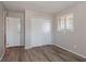 A bedroom featuring wood-look floors, a closet, and a bright window, offering ample storage at 5938 Baywood Ln, Riverdale, GA 30296