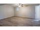 Bedroom featuring wood-look floors, neutral paint, ceiling fan, and a bright window, offering a clean space at 5938 Baywood Ln, Riverdale, GA 30296