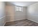This bedroom boasts hardwood floors, neutral walls, and a window at 5938 Baywood Ln, Riverdale, GA 30296