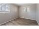 Vacant bedroom featuring two windows with wood-look flooring and neutral walls that would make a comfortable space at 5938 Baywood Ln, Riverdale, GA 30296