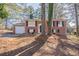 Charming two-story brick home featuring a well-kept front yard and attached garage with a concrete driveway at 5938 Baywood Ln, Riverdale, GA 30296
