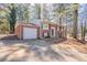 This is a beautiful two-story brick home with an attached garage and plenty of trees and a large driveway at 5938 Baywood Ln, Riverdale, GA 30296