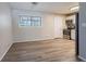Bright kitchen area featuring stainless steel appliances, hardwood floors, and white kitchen cabinets at 5938 Baywood Ln, Riverdale, GA 30296