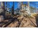 House with a large backyard, partially wooded, and a patio at 2105 Sandtree Sw Ct, Atlanta, GA 30331