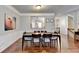 Open concept dining room with hardwood floors and kitchen view at 4942 Payson Se Way, Atlanta, GA 30339