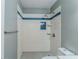 Modern bathroom with a tiled shower, a blue decorative stripe and a hexagon tiled floor at 920 Navajo Trl, Covington, GA 30016