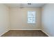 Bright bedroom with neutral walls, carpet flooring, and a window providing natural light at 920 Navajo Trl, Covington, GA 30016