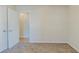 Bedroom with neutral paint, carpet, and a view into an adjacent room at 920 Navajo Trl, Covington, GA 30016