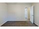 Spacious bedroom with neutral walls, carpet flooring, and an open doorway at 920 Navajo Trl, Covington, GA 30016