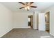 Bright bedroom with a ceiling fan and neutral carpet flooring at 920 Navajo Trl, Covington, GA 30016