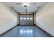 Clean and spacious one-car garage with painted floor and an automatic door at 920 Navajo Trl, Covington, GA 30016