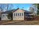 Charming home showcasing a well-manicured backyard, cozy deck, and inviting sunroom at 219 Thorncrest, Stockbridge, GA 30281