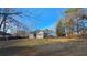 Large, fenced backyard featuring a well-maintained lawn, fire pit, and a charming deck at 219 Thorncrest, Stockbridge, GA 30281