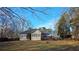 Large, fenced backyard featuring a well-maintained lawn, fire pit, and a charming deck at 219 Thorncrest, Stockbridge, GA 30281