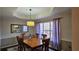 Charming dining room features a traditional wood table with seating for six and decorative light fixture at 219 Thorncrest, Stockbridge, GA 30281