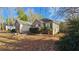 Landscaped home featuring brick and beige exterior walls, dark shutters, and trimmed bushes at 219 Thorncrest, Stockbridge, GA 30281