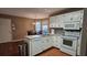 Bright kitchen with white cabinets, modern appliances, laminate countertops and breakfast nook in view at 219 Thorncrest, Stockbridge, GA 30281
