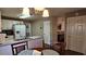 Eat-in kitchen with white cabinets, laminate countertops, and stainless steel appliances with adjacent dining area at 219 Thorncrest, Stockbridge, GA 30281