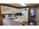 Well-lit kitchen features white cabinets, modern appliances, and view into the breakfast and dining areas at 219 Thorncrest, Stockbridge, GA 30281
