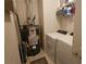 Functional laundry room with white washer and dryer and practical shelving for storage solutions at 219 Thorncrest, Stockbridge, GA 30281