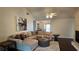 Inviting living room features a large sectional sofa, modern ceiling fan and stylish decor at 219 Thorncrest, Stockbridge, GA 30281