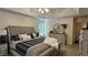 Bright main bedroom featuring tray ceilings, a plush bed, and a decorative dresser at 219 Thorncrest, Stockbridge, GA 30281