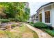 Stone pathway meanders through a well-manicured backyard leading to a deck at 4005 Chelsea Ln, Marietta, GA 30062