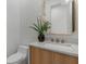 Modern powder room with marble vanity, gold accents, and patterned tile at 4063 Rickenbacker Dr, Atlanta, GA 30342